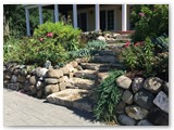 boulder_wall_with_garden_and_stamped_concrete_03